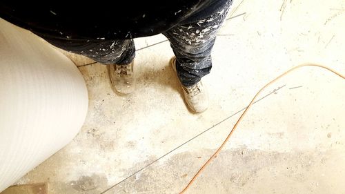 Low section of woman standing on tiled floor