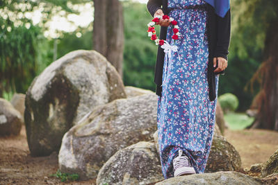 Low section of woman standing on rock