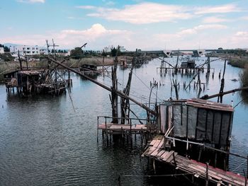 Abandoned ship moored in water against sky