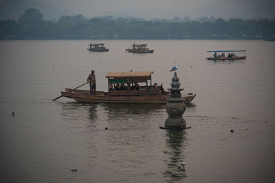 Boat sailing in lake against sky