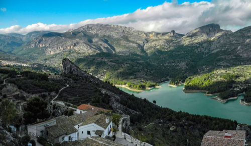 Scenic view of mountain range against cloudy sky