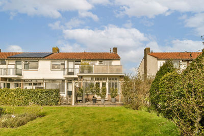 Houses on field against sky