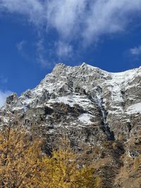 Low angle view of snowcapped mountain against sky