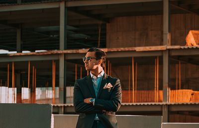 Full length of young man wearing sunglasses standing indoors