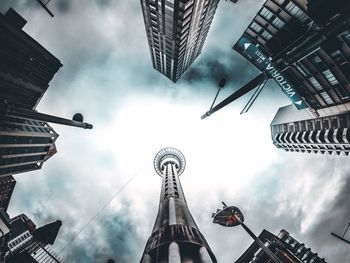 Low angle view of buildings against cloudy sky