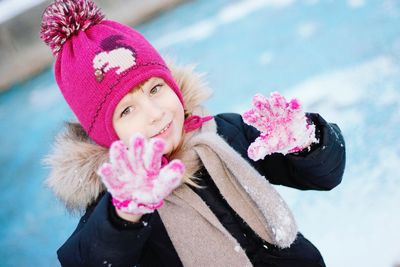 Close-up portrait of cute girl gesturing during winter