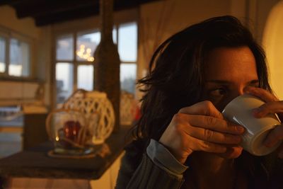 Portrait of woman with coffee cup on table