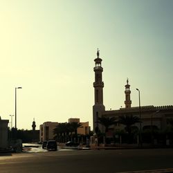 Road in city against clear sky