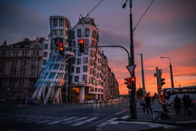 People on road against sky at sunset