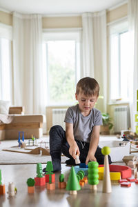 Boy playing with toys at home