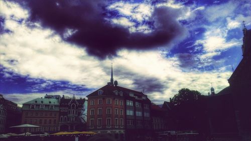 Low angle view of building against cloudy sky