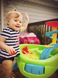 Cute baby boy smiling while sitting on seat