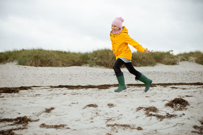 Full length of girl running at beach