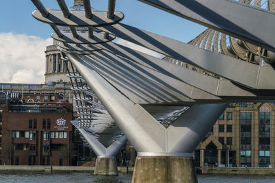 Low angle view of bridge over buildings against sky