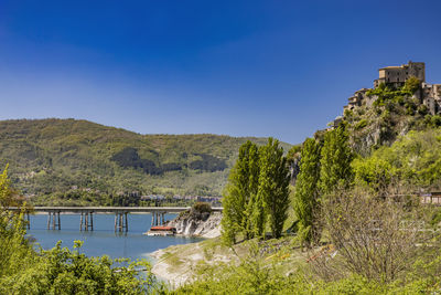 Scenic view of sea against clear blue sky