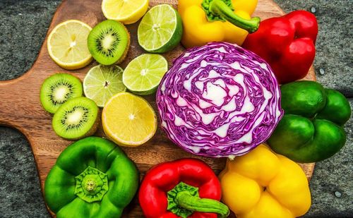 High angle view of vegetables and fruits on cutting board