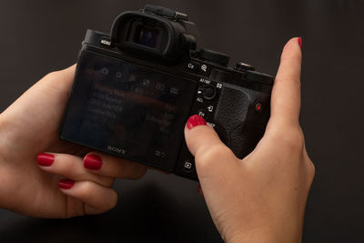 Midsection of woman photographing with mobile phone