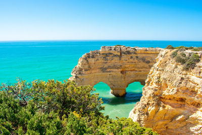 Scenic view of sea against clear blue sky