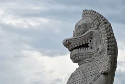 Statue against cloudy sky