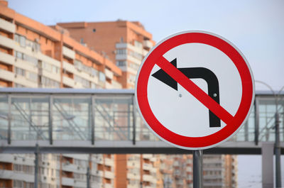 Road sign against buildings in city