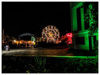 Illuminated ferris wheel at night