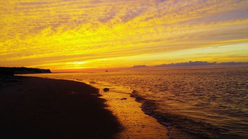 Scenic view of beach against sky during sunset