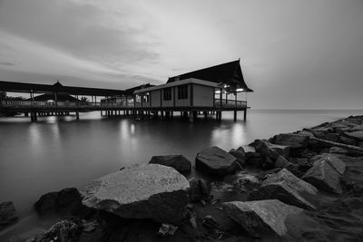 Scenic view of sea by buildings against sky