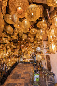 Low angle view of illuminated pendant lights hanging from ceiling