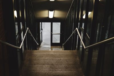 High angle view of steps leading towards glass door