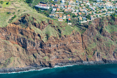 High angle view of buildings by sea