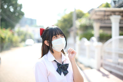 Portrait of young woman standing outdoors