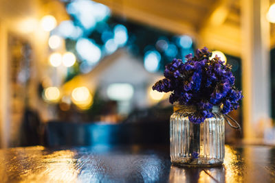 Close-up of purple flowers in mason jar at table