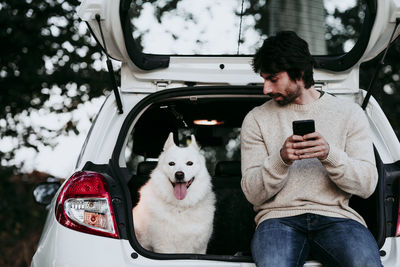 Side view of a dog on smart phone