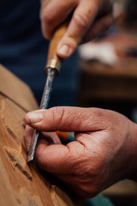 Close-up of man working on wood