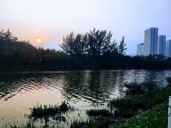 Scenic view of river against sky during sunset