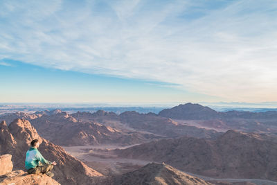 Scenic view of mountains against cloudy sky