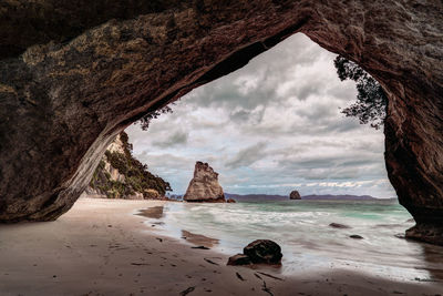 View of beach against cloudy sky