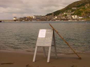 Lifeguard hut on beach against sky