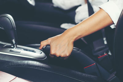 Midsection of man sitting in car