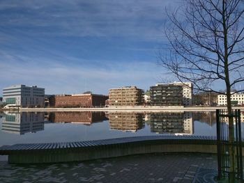 Reflection of buildings in lake against sky