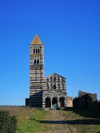 Low angle view of old building against clear blue sky