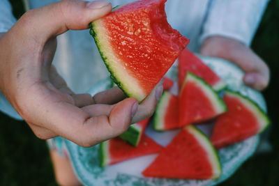 Close-up of hand holding strawberry