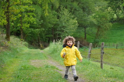 Full length of girl standing in forest