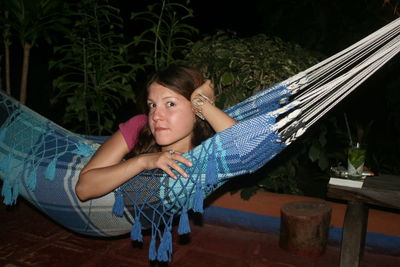 Portrait of young woman in hammock