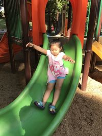 Full length of cute girl playing in playground