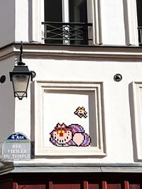 Low angle view of clock on window of building