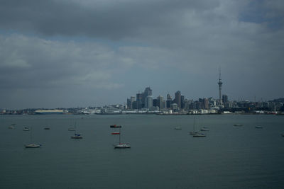 Boats in sea against sky
