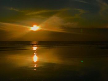Scenic view of sea against sunset sky