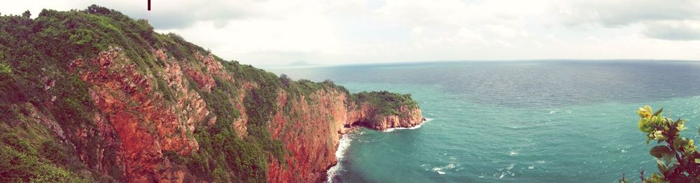 Scenic view of sea against cloudy sky