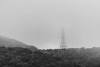 Low angle view of electricity pylon against sky